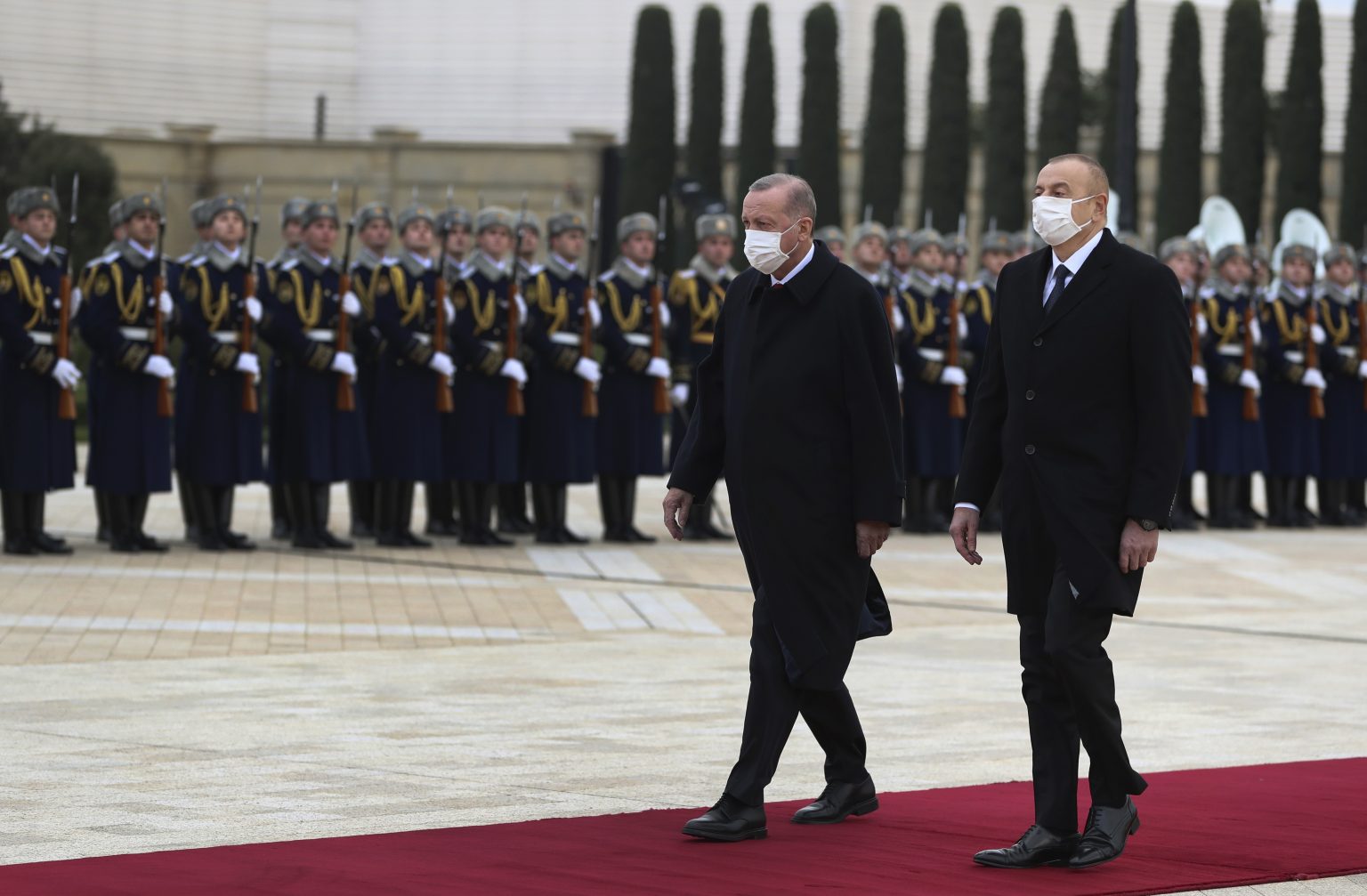 Azerbajdžanský prezident Ilham Alijev (vpravo) kráča s tureckým prezidentom Recepom Tayyipom Erdoganom počas prehliadky čestnej stráže pred ich stretnutím v Baku 9. decembra 2020. Foto: TASR/AP