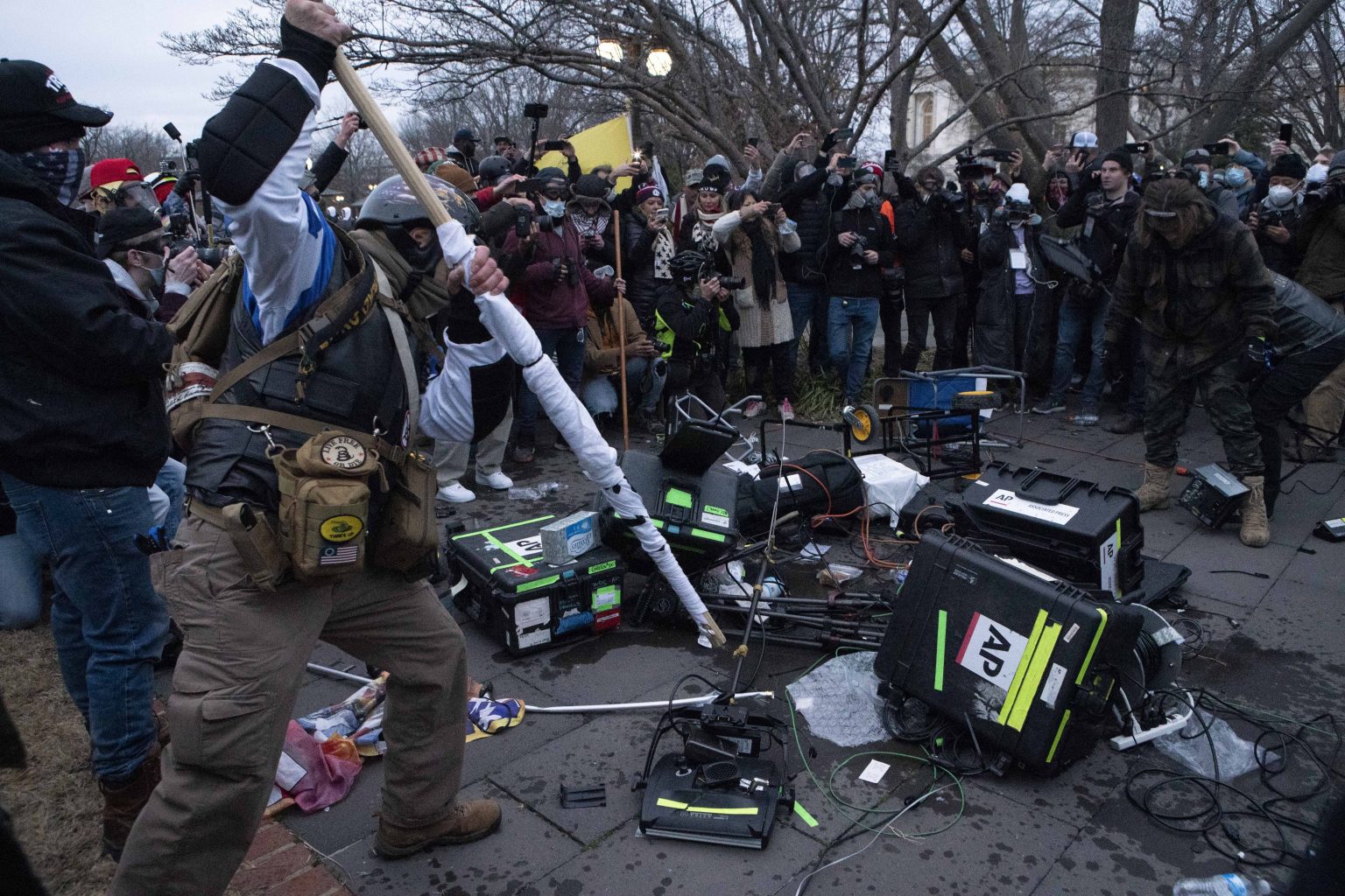 Demonštranti rozbíjajú techniku novinárom pred budovou Kapitolu. Foto: TASR/AP