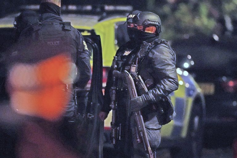 Ozbrojení policajti hliadkujú po výbuchu taxíka, ktorý sa odohral pred nemocnicou v Liverpoole 14. novembra 2021. Po výbuchu polícia zatkla troch mužov. Foto: TASR/AP