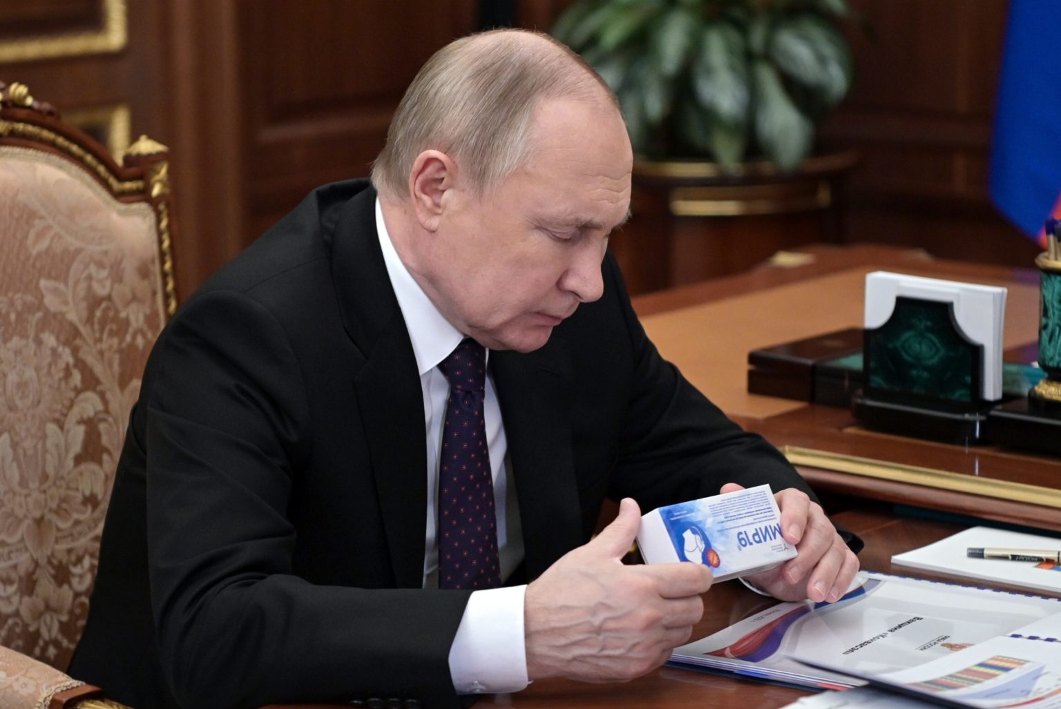 Ruský prezident Vladimir Putin sa pozerá na krabičku liekov MIR 19 na liečbu koronavírus. Foto: TASR/AP
