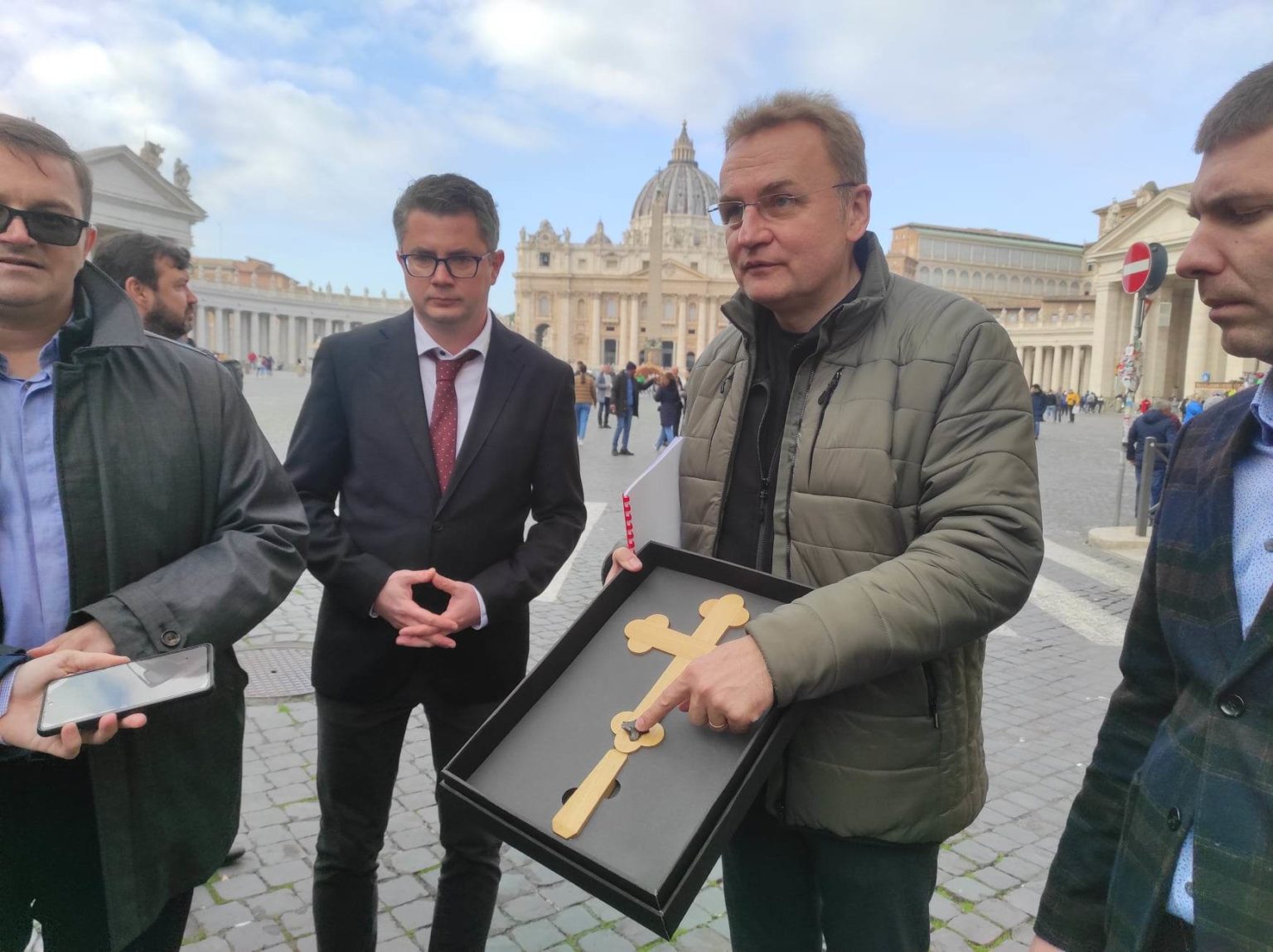 Starosta Ľvova vo Vatikáne ukazuje kríž s kusom bomby, ktorý lekári vytiahli z tela malého dievčaťa. Foto: Bohumil Petrík