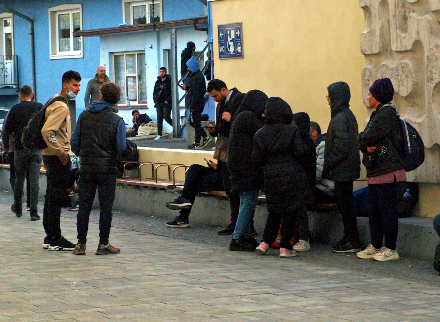 Na snímke migranti sedia na lavičke v blízkosti hlavnej železničnej stanice v Bratislave v utorok 17. októbra 2023. Foto: Miroslav Košírer/TASR