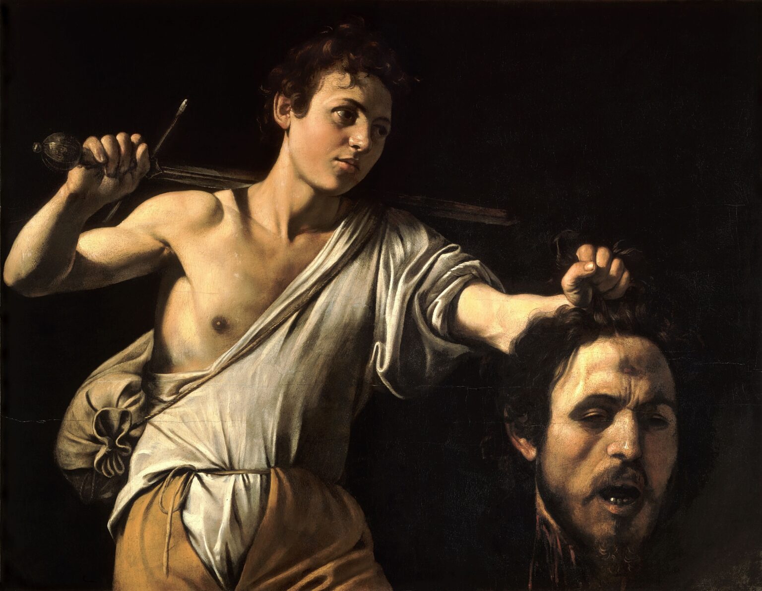 Caravaggio: David s hlavou Goliáša, olej na plátne, 1606-7. Zdroj: Wikimedia