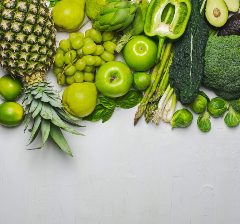 Green vegetables and fruits on a white background. Photo: Anjelika Gretskaia/REDA/Universal Images Group via Getty Images