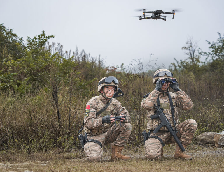Armed police officers conduct an anti-terrorism drill using drones in Guiyang, Guizhou province, China. Photo: Costfoto / NurPhoto / Getty Images