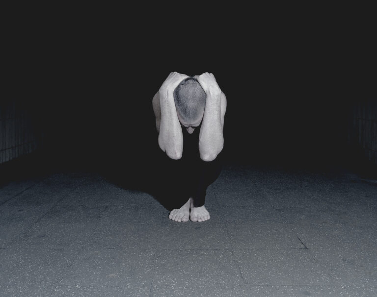 Man crouching in urban environment. Photo: Robert Daly / Getty Images 