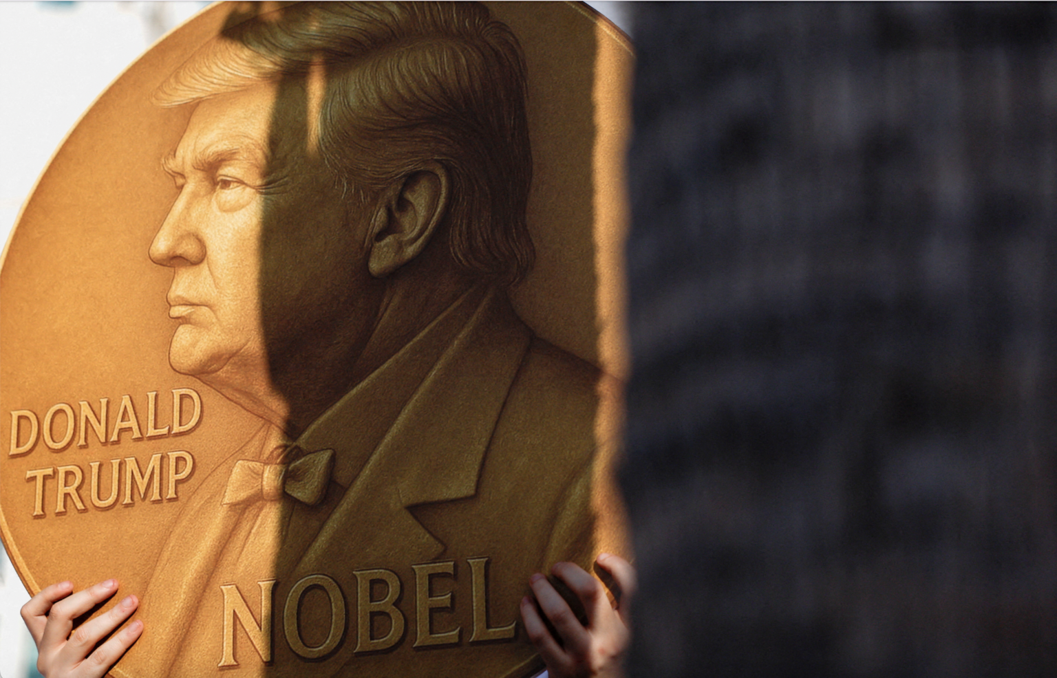 A protester holds a poster with a picture of Donald Trump and the word “Nobel” during a gathering of supporters and family members of kidnapped hostages. Photo: REUTERS/Ammar Awad/File Photo