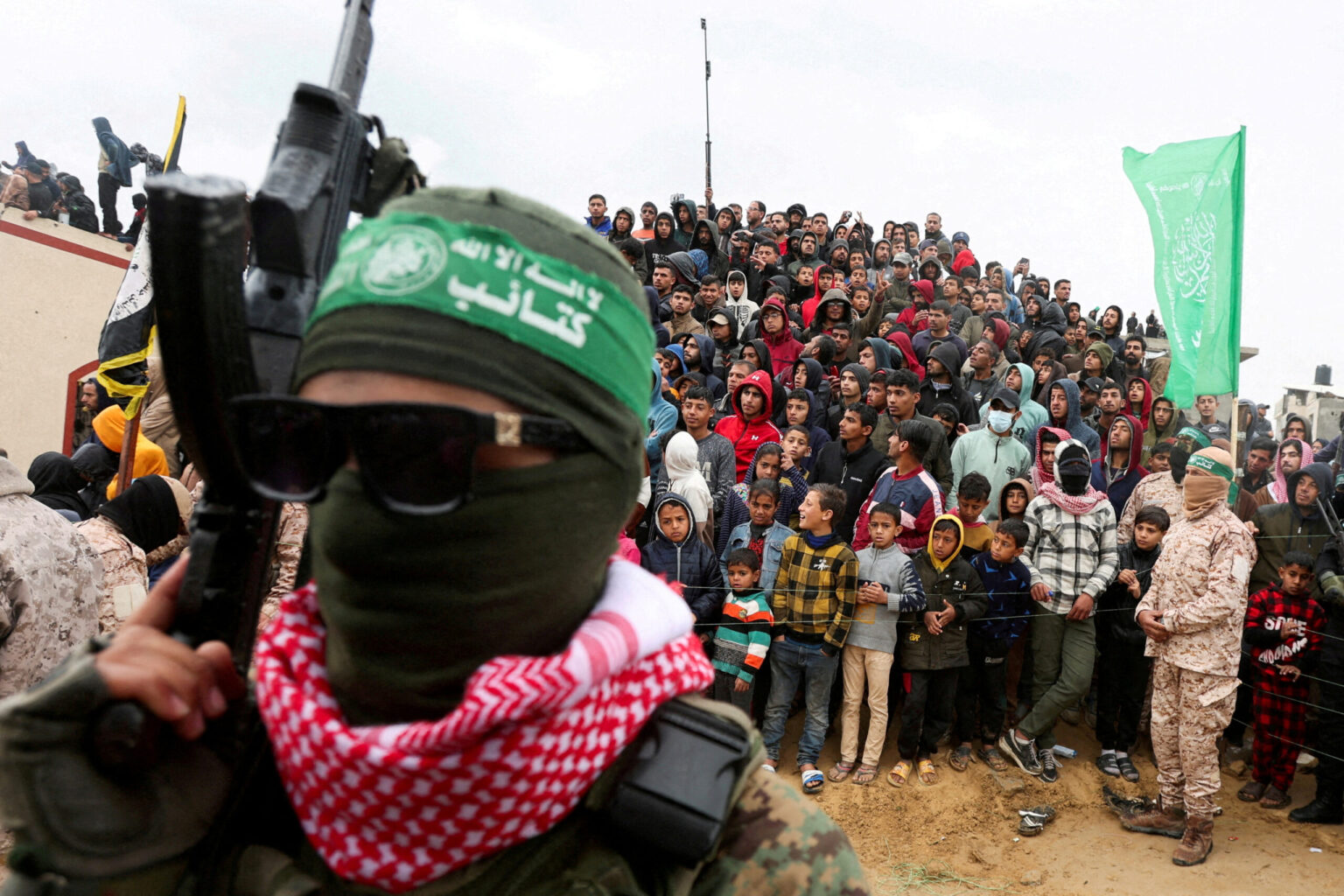 Palestinians watch as Hamas hands over Israeli hostages’ remains to the Red Cross in Khan Younis on 20 February 2025. The latest US findings have renewed scrutiny of UNRWA staff involvement in the 7 October attacks. Photo: Ramadan Abed/Reuters