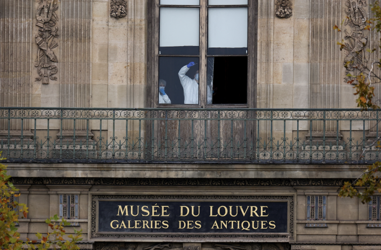 Investigators at the Louvre. Photo: Gonzalo Fuentes/Reuters