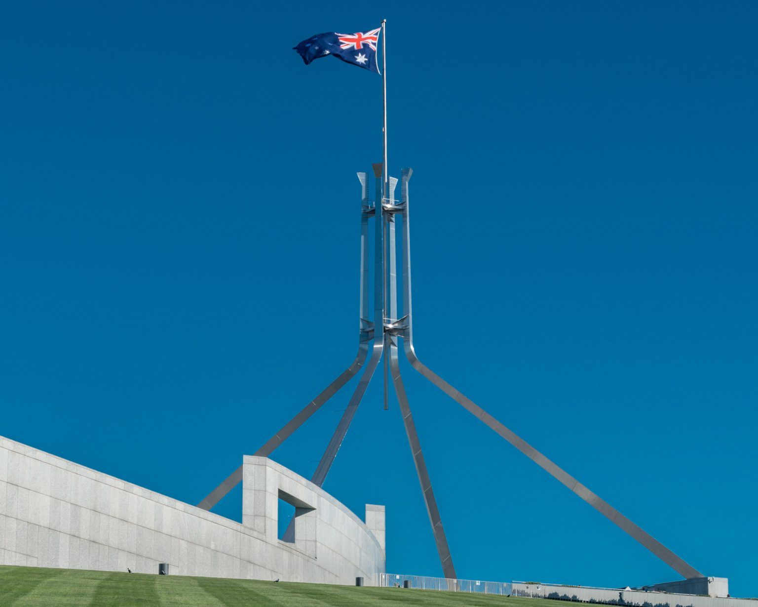 Flag flying over the Australia Parliament Building in the capital of Canberra. Photo: Rex_Wholster/Getty Images