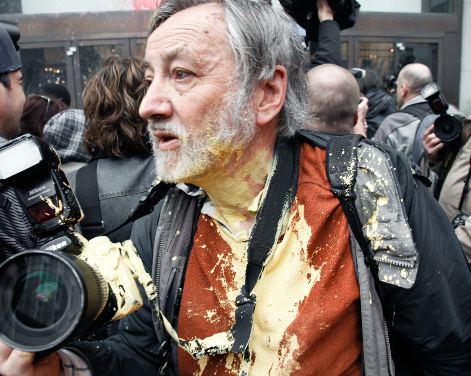 A press photographer moments after being splashed with paint, his camera and clothing covered during the confrontation. Photo: Mike Kemp/In Pictures Ltd./Corbis/Getty Images