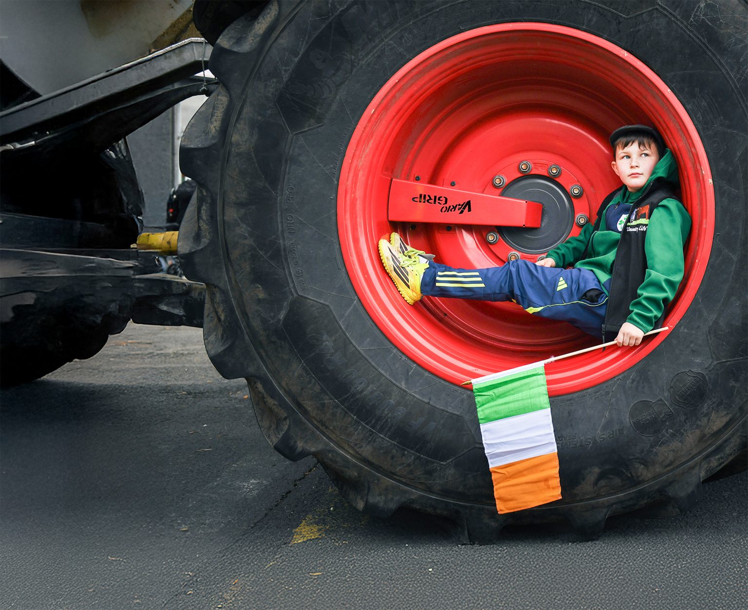 A young boy from a farming community sits in the wheel of a stationary tractor and watches as fuel protesters block O'Connell Street on 11 April 2026 in Dublin, Ireland. Photo: Charles McQuillan/Getty Images