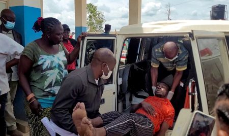 A man is carried from an ambulance after Ebola outbreak confirmation.