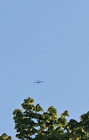An aircraft flies over a village after a drone entered the airspace.