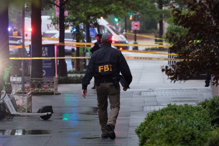 An FBI agent walks near the White House.