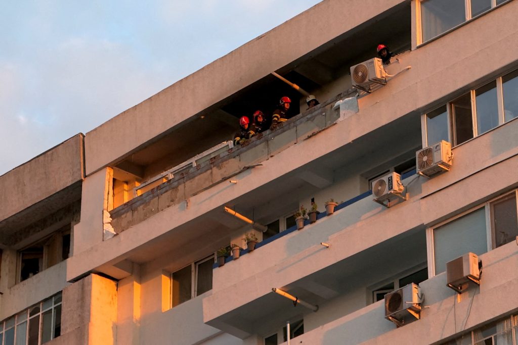 Firefighters work on the site of an explosion at a residential block of flats following a drone hit in Galati, Romania. Photo: REUTERS