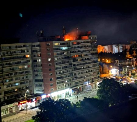 Požiar na streche bytového domu po náraze dronu.