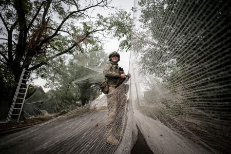 Serviceman installs anti-drone nets.
