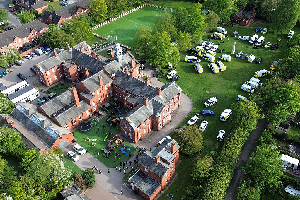 Police at Webb House in Crewe, the headquarters of the Ahmadi Religion of Peace and Light, where 10 people were arrested. Photo: Ryan Jenkinson/Getty Images