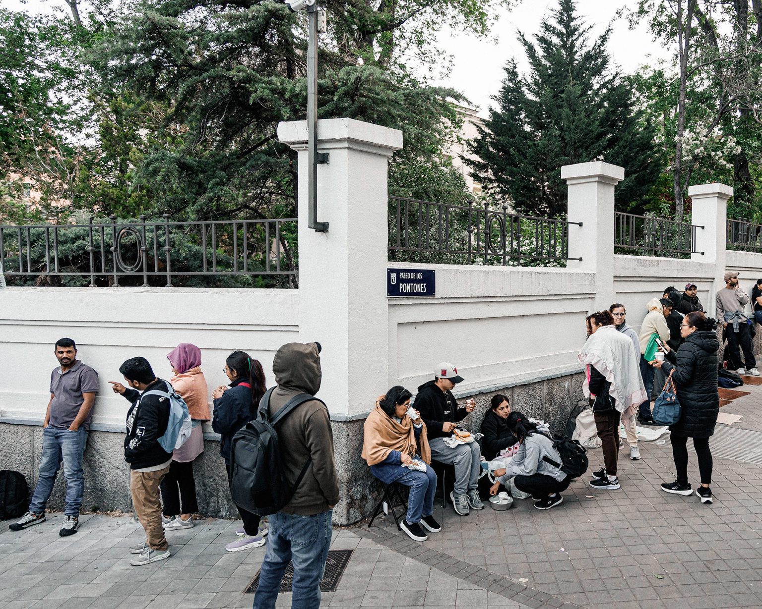 Migrants queue for documents in Spain.