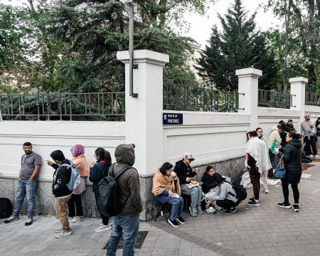 Migrants queue for documents in Spain.