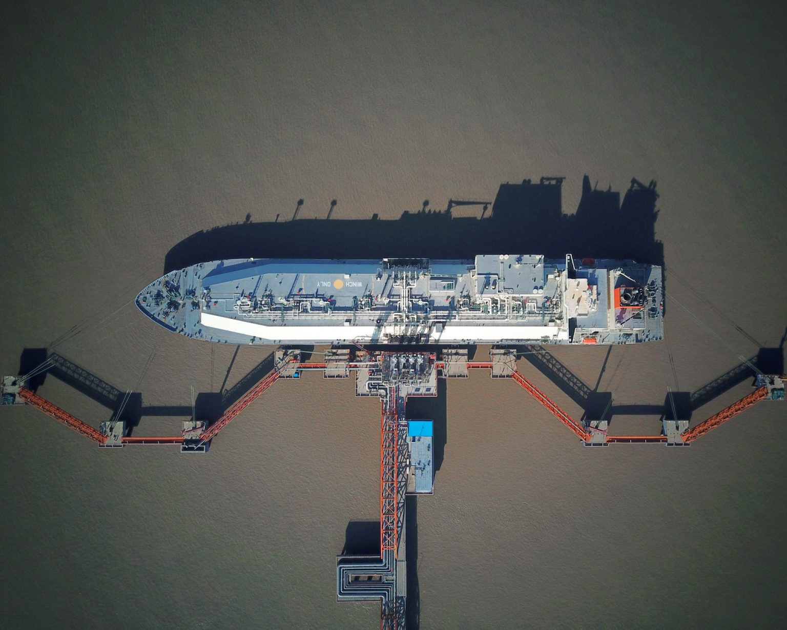 A liquefied natural gas (LNG) tanker sits docked at the LNG terminal
