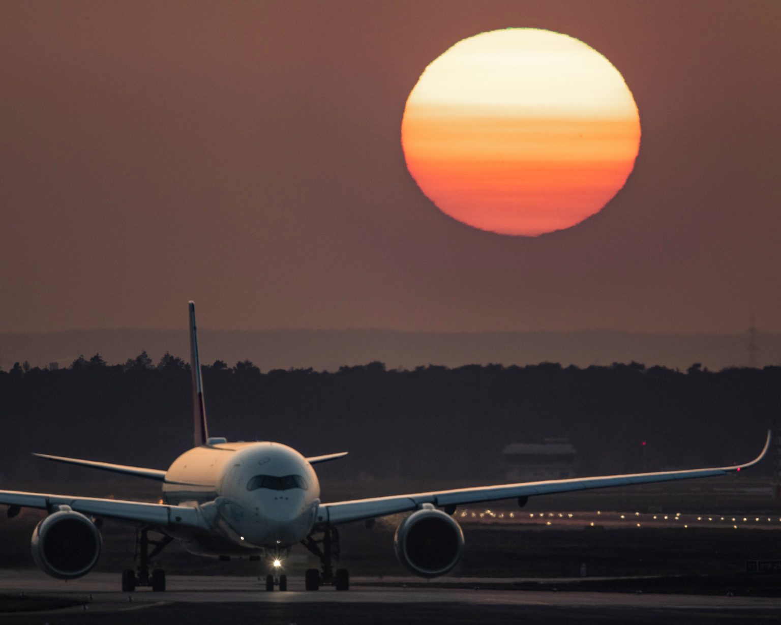 Cargo plane at Frankfurt Airport during sunset.