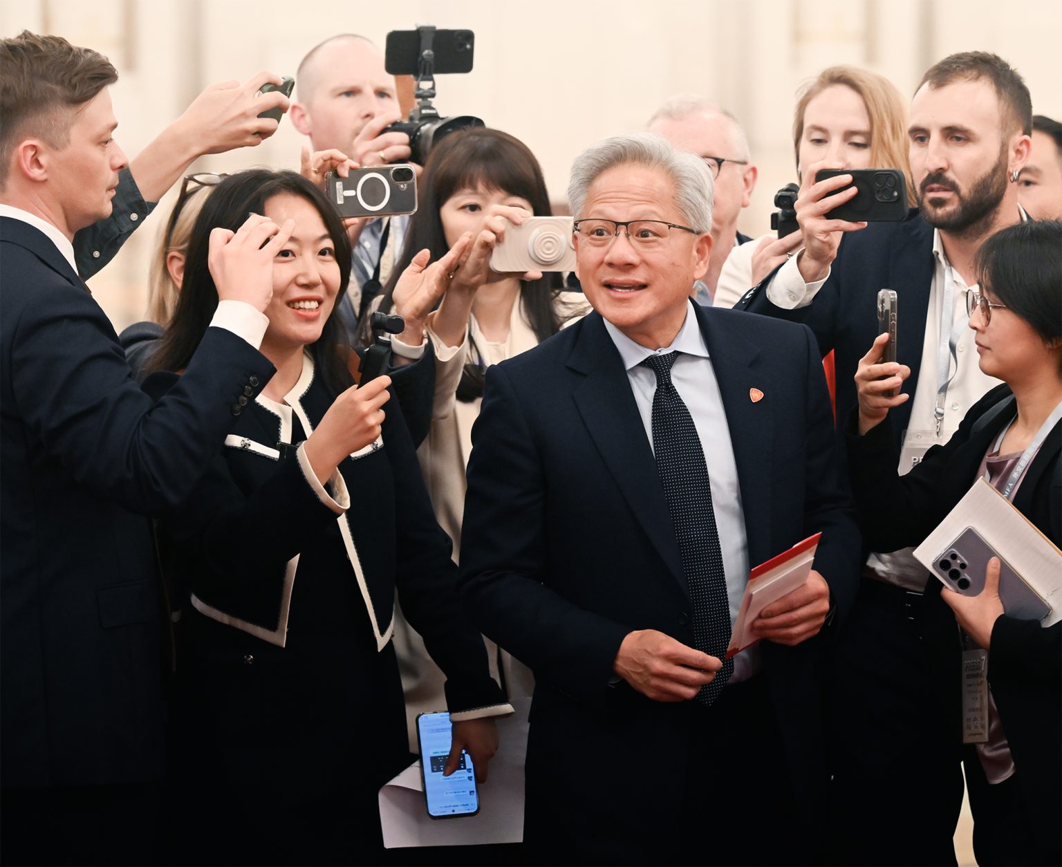 Nvidia CEO Jensen Huang is surrounded by photographers at the Great Hall of the People in Beijing on 14 May 2026. Photo: Tian Yuhao/China News Service/VCG via Getty Images
