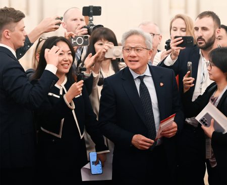 Nvidia CEO Jensen Huang is surrounded by photographers at the Great Hall of the People in Beijing on 14 May 2026. Photo: Tian Yuhao/China News Service/VCG via Getty Images