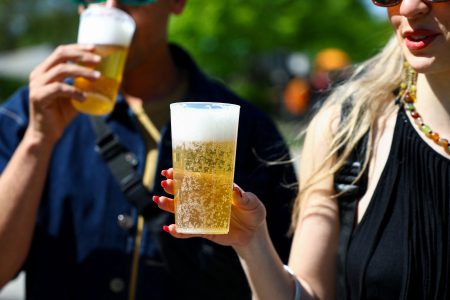 People hold beers.