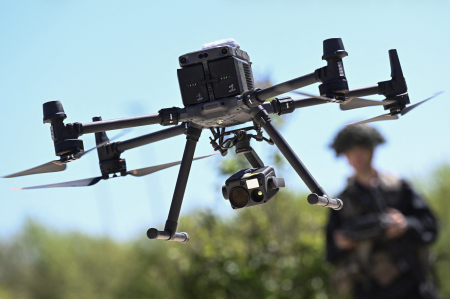 A soldier pilots a drone.