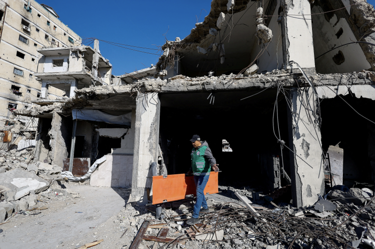 Palestinians survey the site of an Israeli attack on a police station in Gaza City. Photo: Mahmoud Issa/Reuters