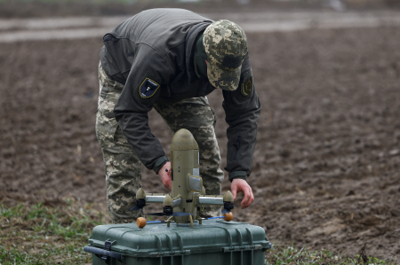 A Ukrainian soldier prepares a combat drone.
