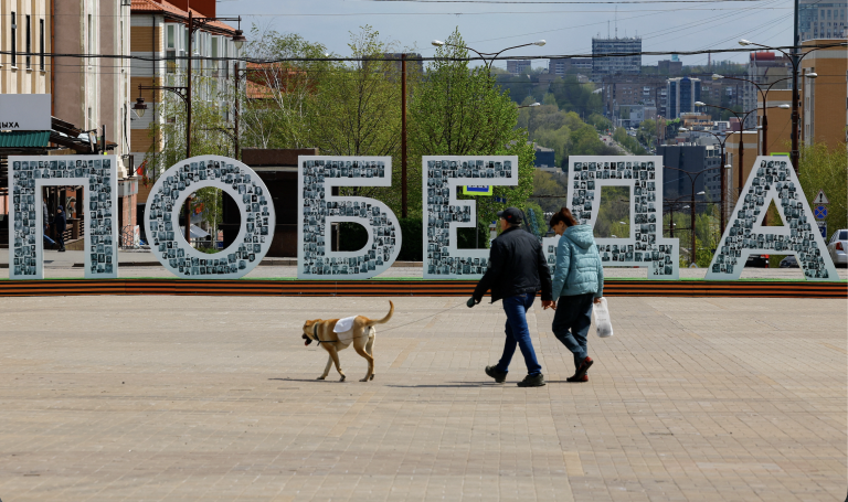 People walk past a Victory installation in Russian-controlled Donetsk, eastern Ukraine. Photo: Alexander Ermochenko/Reuters