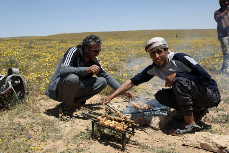 Men are grilling meat in Syria.