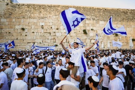 People wave Israeli flags.