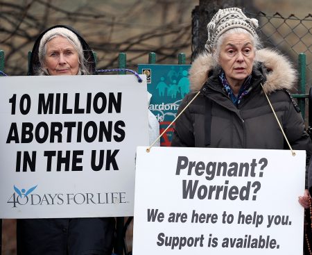 Pro-life demonstrators reach out to women at a clinic.