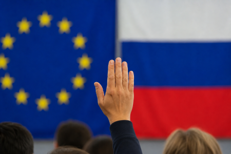 Raised hands and Russian and EU flags.