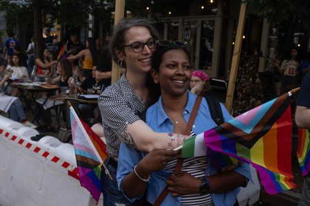 Spectators watch the Brooklyn Gay Pride Parade.