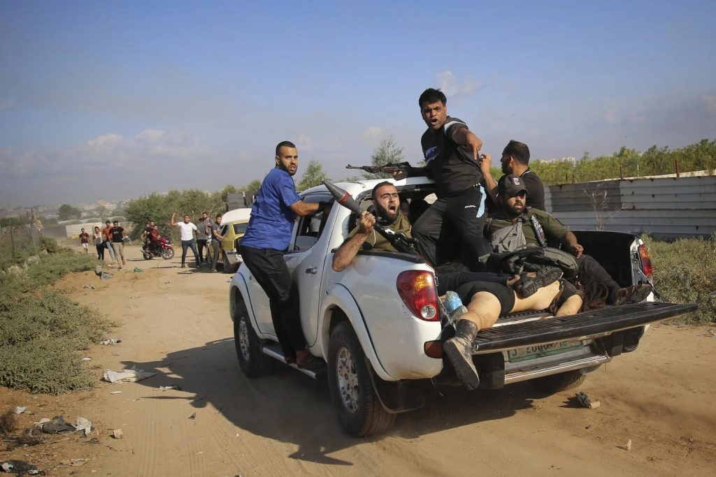 Palestinian militants drive back to the Gaza Strip with the body of Shani Louk, a German-Israeli dual citizen, during their cross-border attack on Israel, Saturday, Oct. 7, 2023. Photo: Ali Mahmud