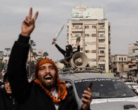 Soldiers celebrating in the city of Hama.