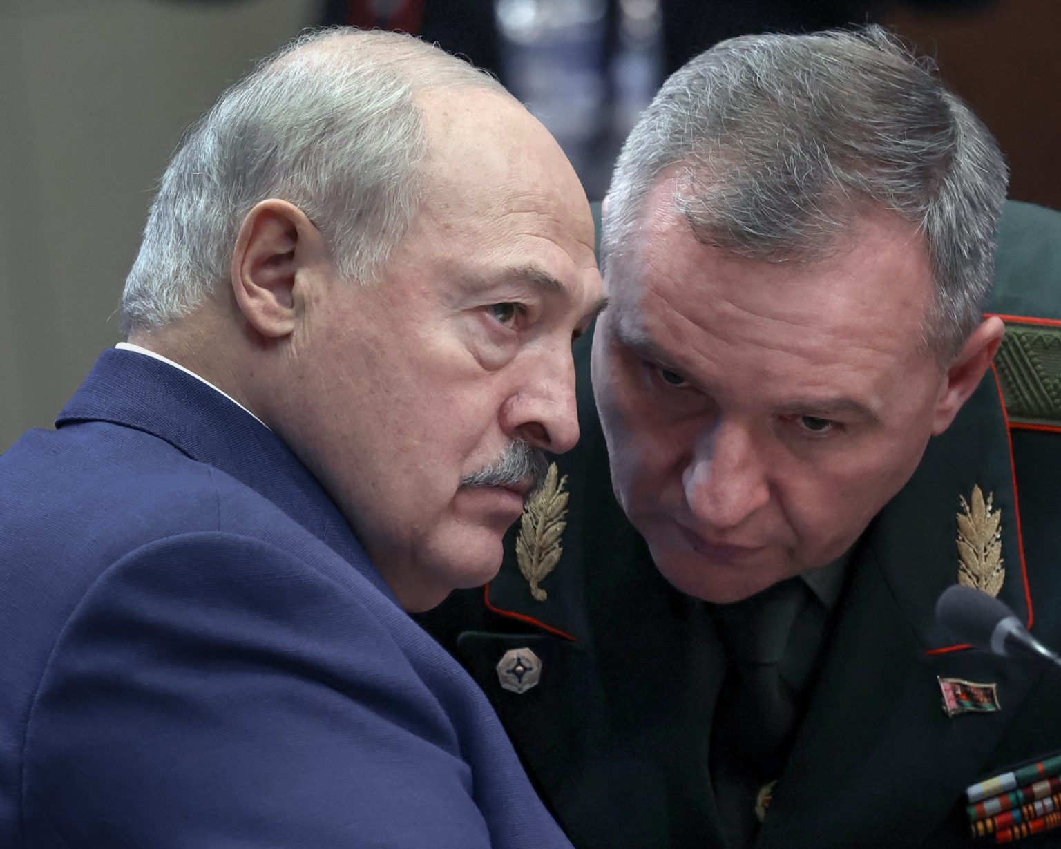 Belarusian President Alexander Lukashenko listens to Defence Minister Viktor Khrenin.