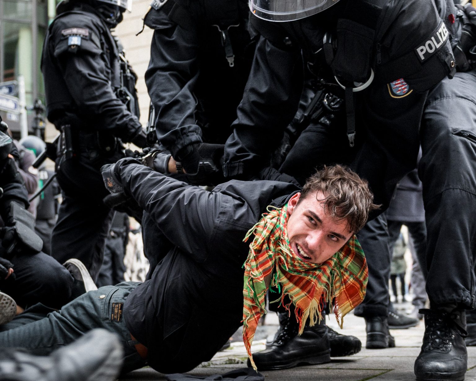 Police restrain an Antifa counterdemonstrator during a protest.