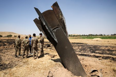 An Iranian missile lodged in a field.