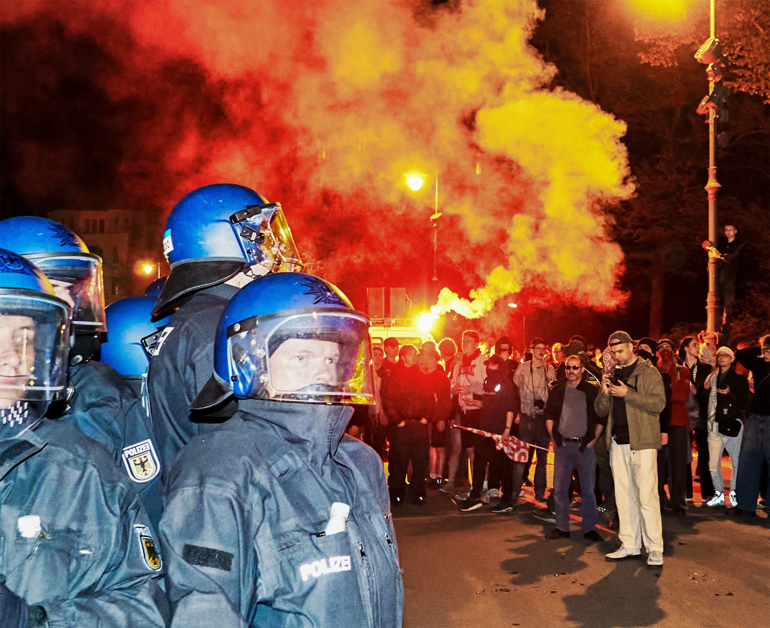 Police officers face protesters in Berlin.