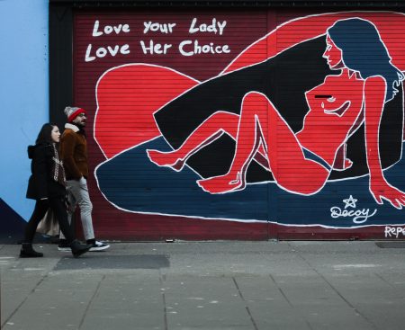 People walk past pro-abortion graffiti in Dublin.