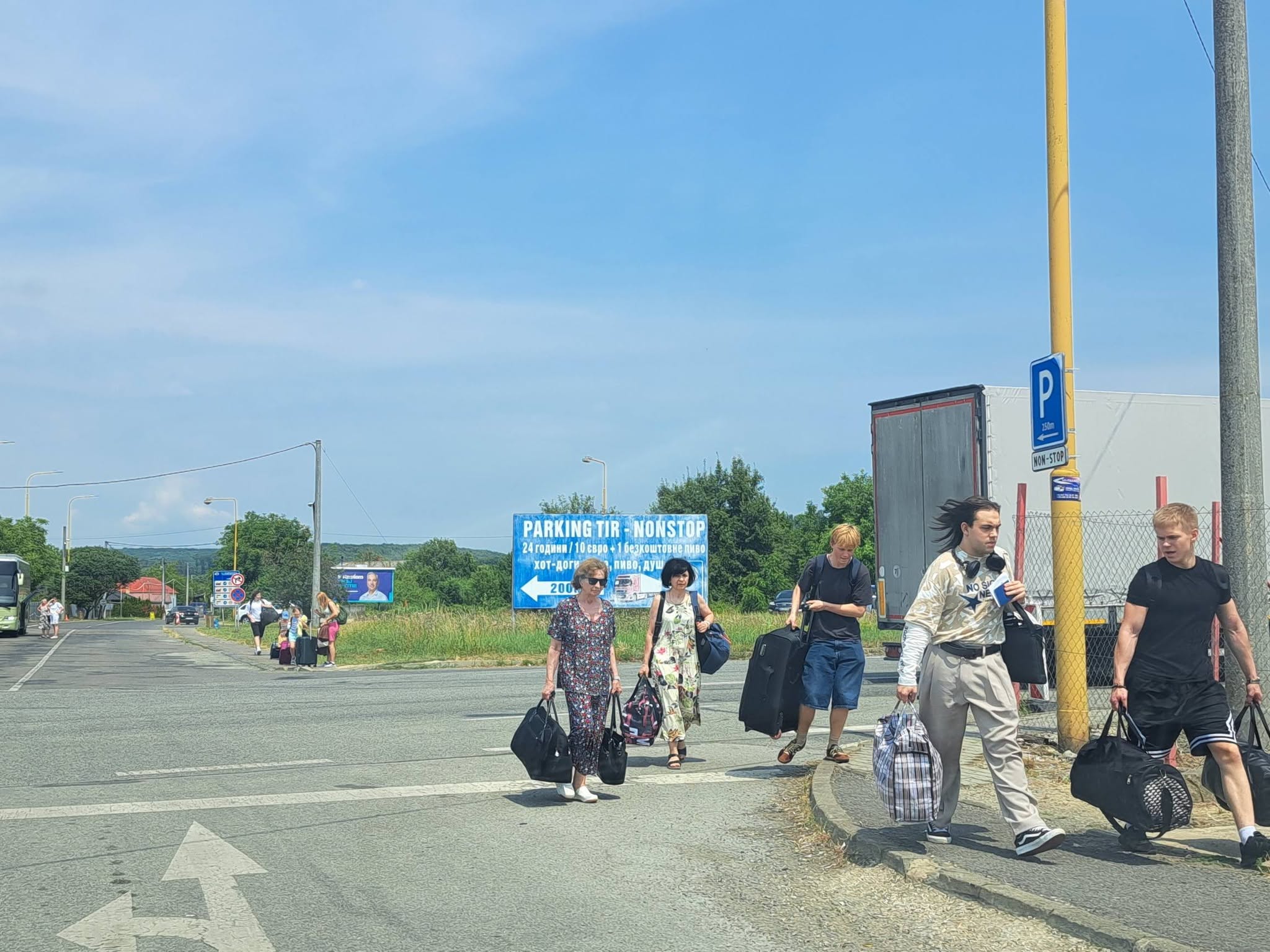 Ľudia idú s batožinou na hranicu peši. V autobuse by čakali dlhšie. Zdroj: EB