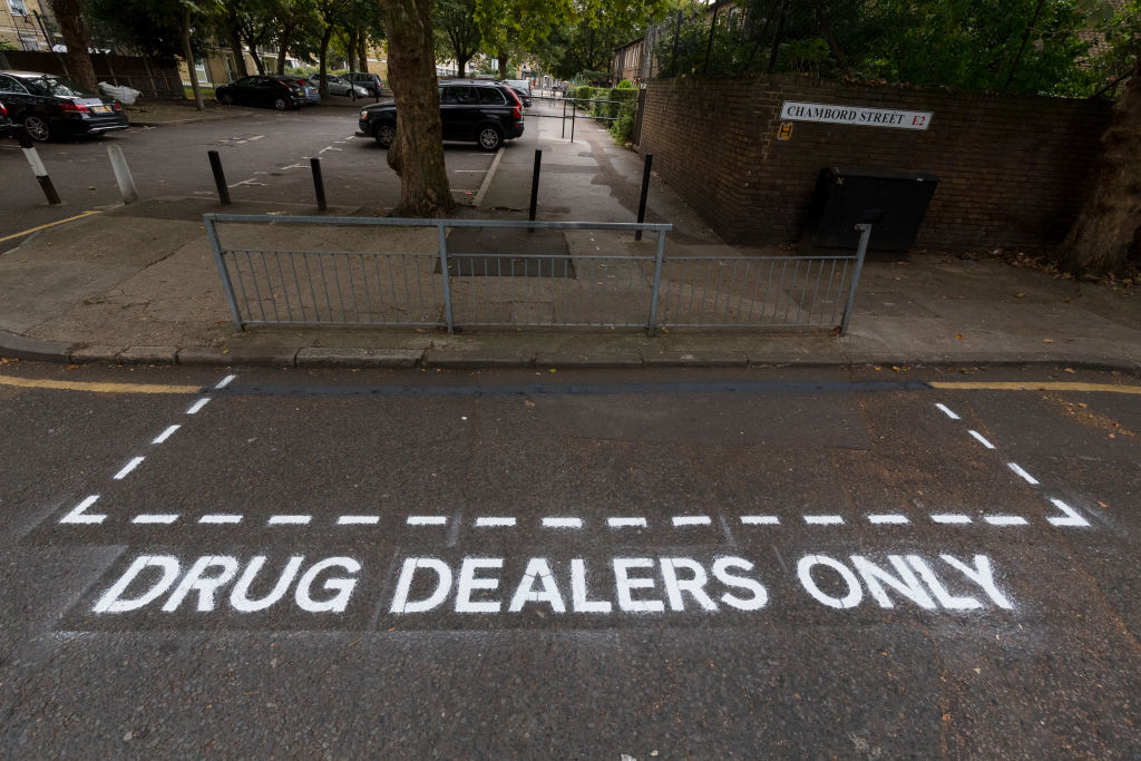 Road markings reading “Drug Dealers Only” in Shoreditch.