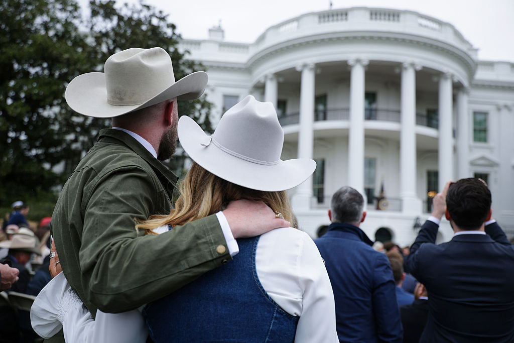 Attendees listen to Donald Trump on the South Lawn.