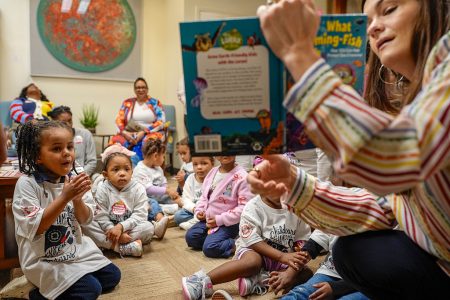 Children listen to a reading at the Wilson Building.